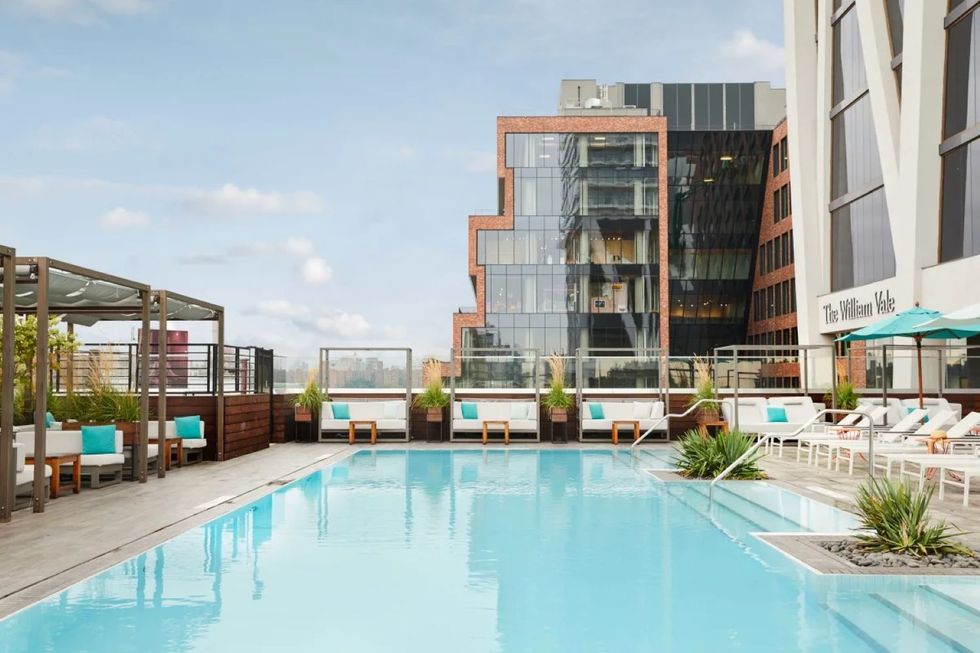 an outdoor pool with views of buildings