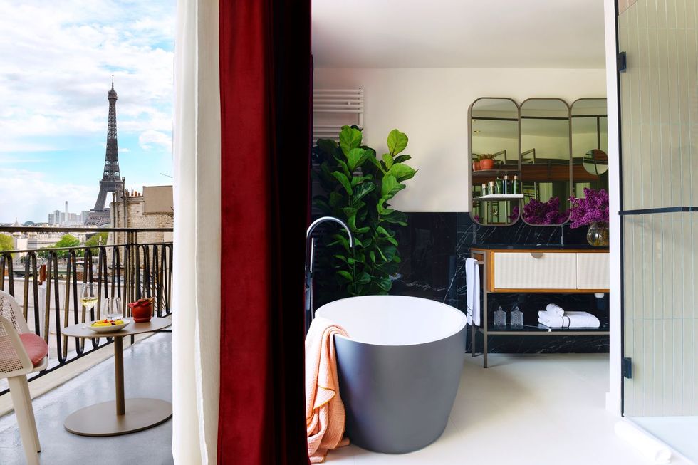 a room with a bathtub and view of the eiffel towers at villa marquis