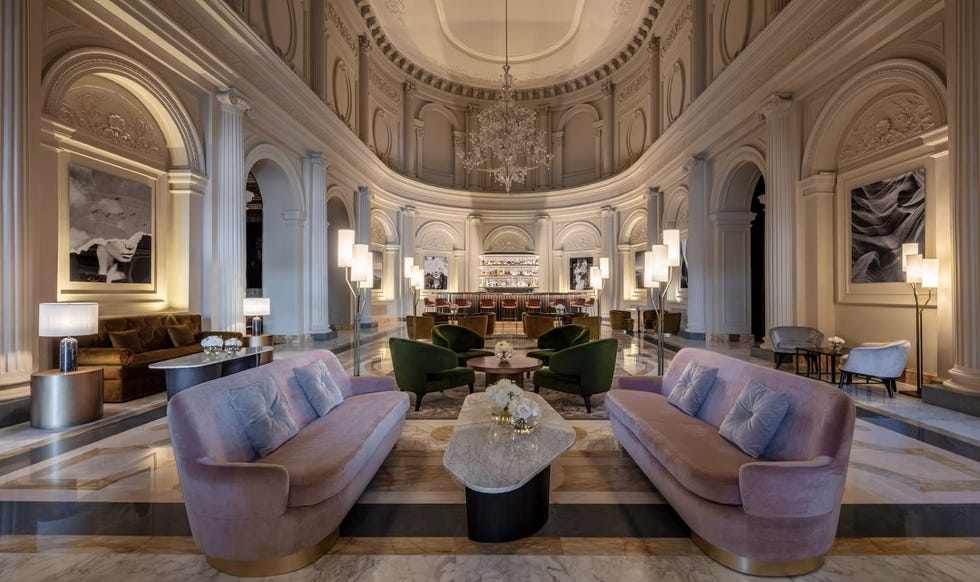 a large room with a bar and seating areas at anantara palazzo naiadi hotel