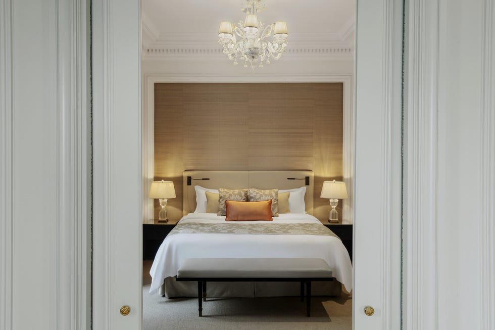 a bed with a white bed spread at st regis