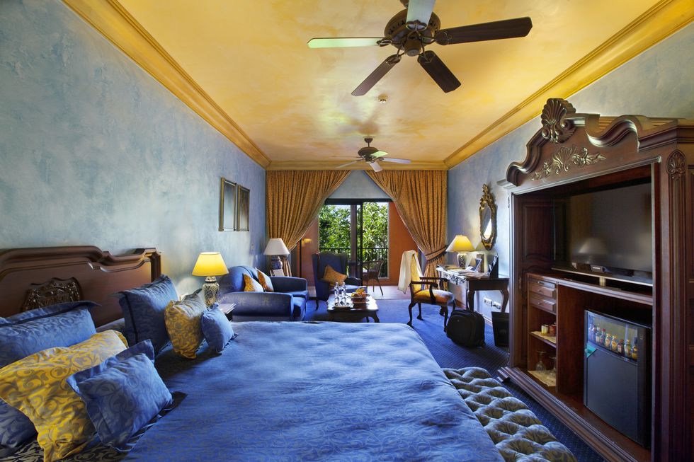 a bedroom with a large blue bed at europe villa cortes