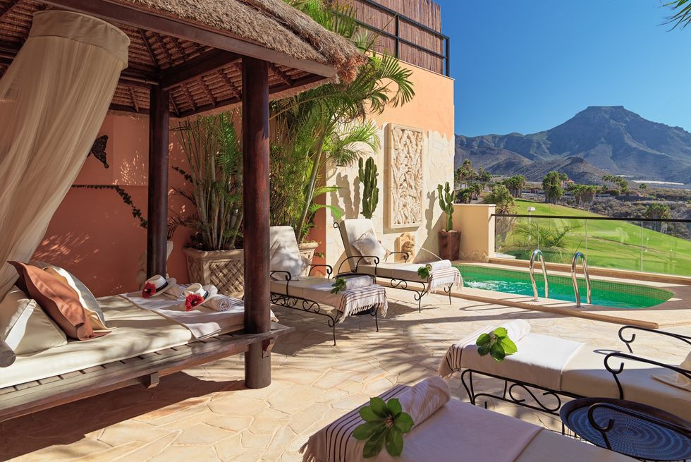 villa with a deck and a view of hills and a valley at royal garden villas and spa