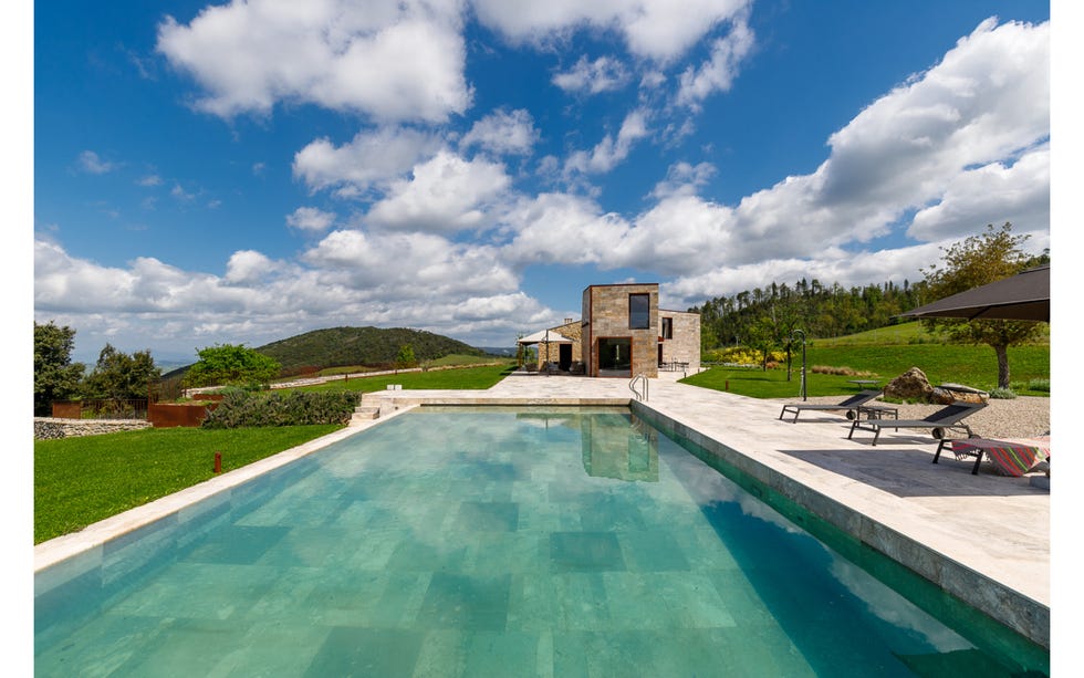 a swimming pool with a house in the background