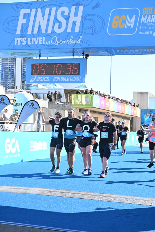 runners cross the finish line of the gold coast marathon