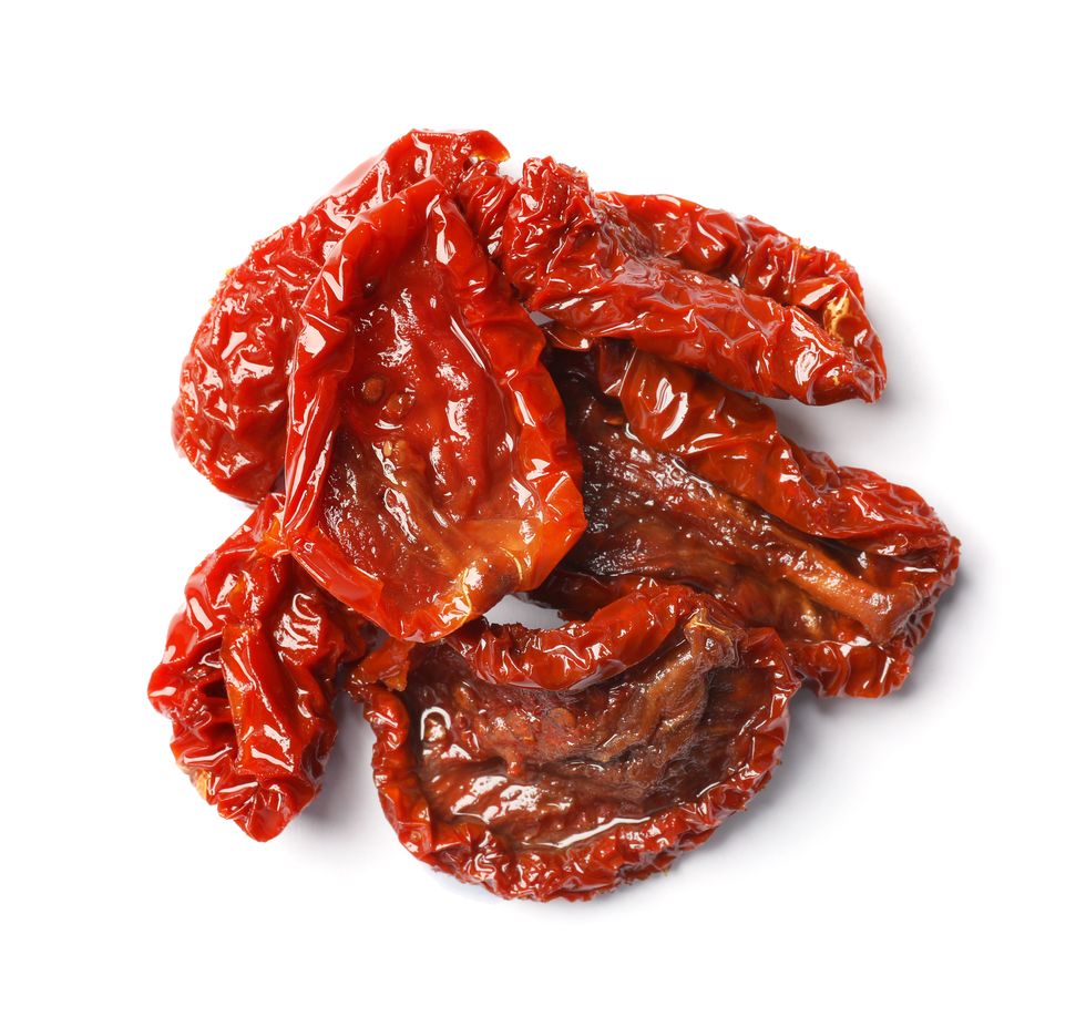 Tasty sun dried tomatoes on white background, top view