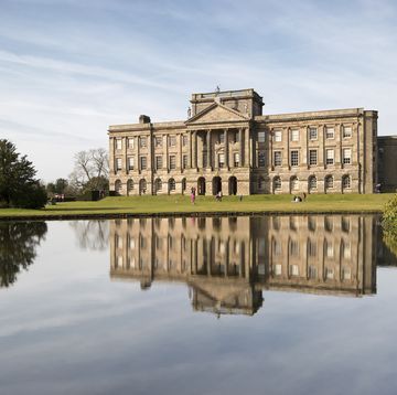 lyme hall reflected in the lake at lyme park, disley, england photo by loop imagesuniversal images group via getty images