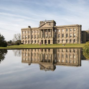 lyme hall reflected in the lake at lyme park, disley, england photo by loop imagesuniversal images group via getty images