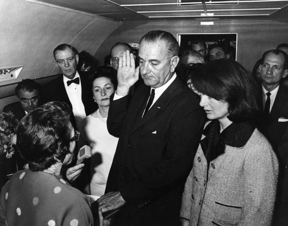 Lyndon B. Johnson is sworn in as the 36th President of the United States on Air Force One after the assassination of President John F Kennedy