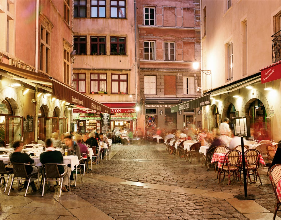 Lyon, People dining along cobbled street at night