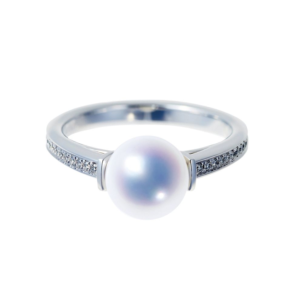 a silver ring with a blue gem