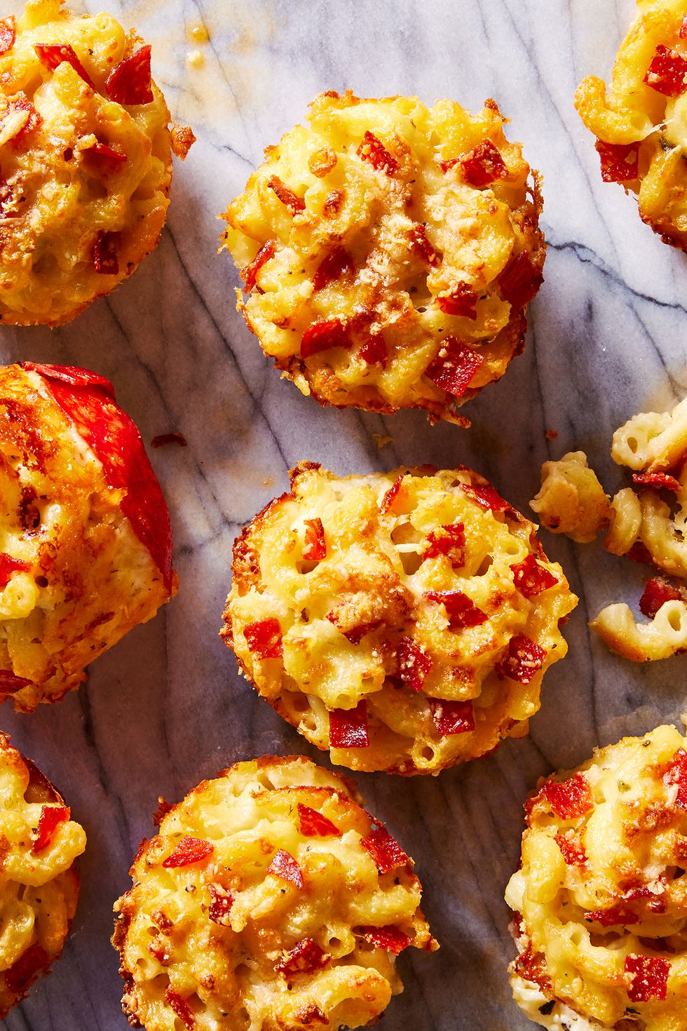 mac and cheese with pepperonis in a muffin tin shape