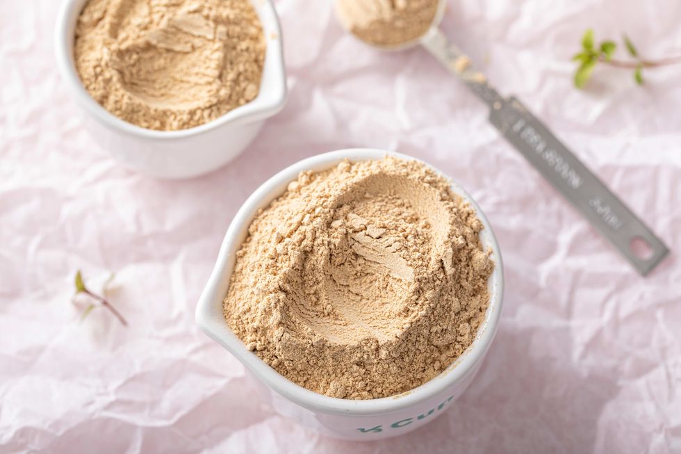 maca powder in measuring cups and a spoon, food supplement