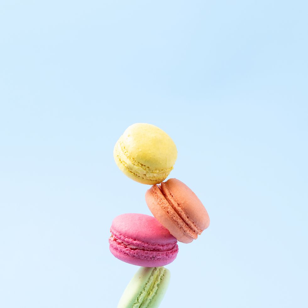 five macaroons balance over blue background
