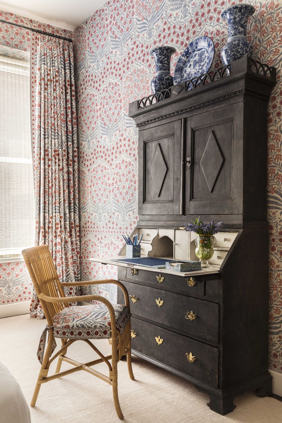 desk, floral wallpaper and floral curtains, wicker chair