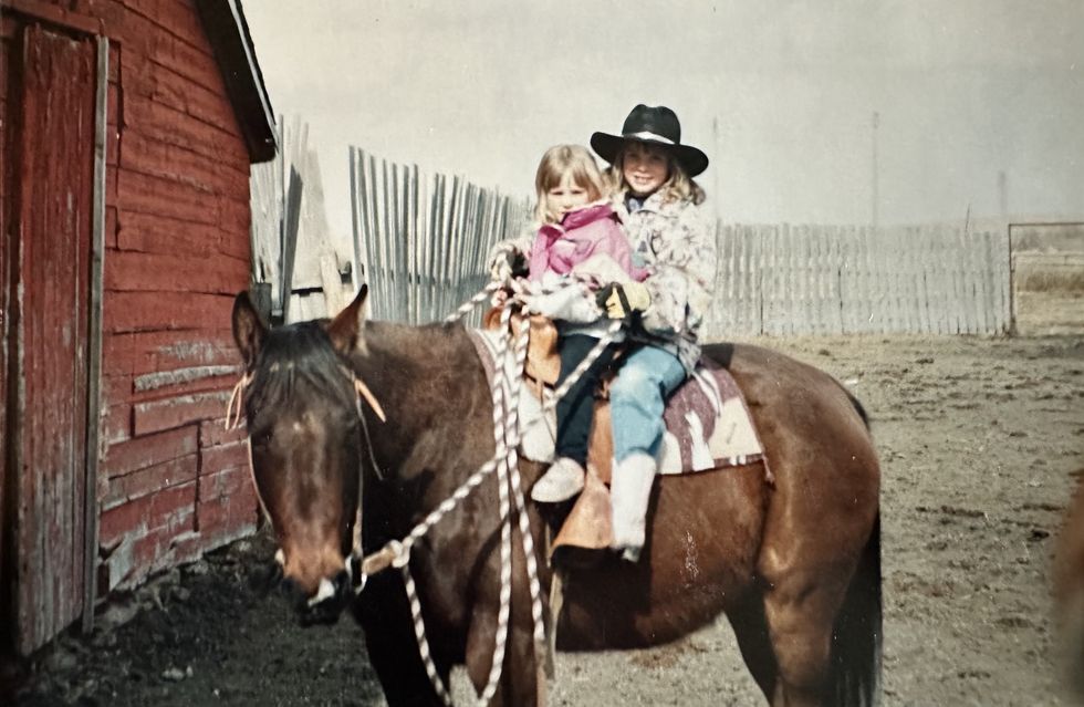 mackenzie porter as a child at the ranch, on horseback with her sister