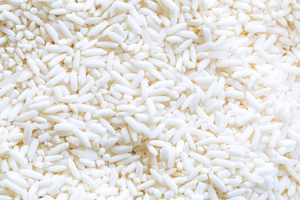 macro rice background,organic white raw jasmine, sticky rice background, white long seeds macro closeup as picture backdrop or background pattern texture