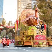 turkey float in nyc with pilgrim marchers and spectators near the start of the 92th annual macys thanksgiving day parade