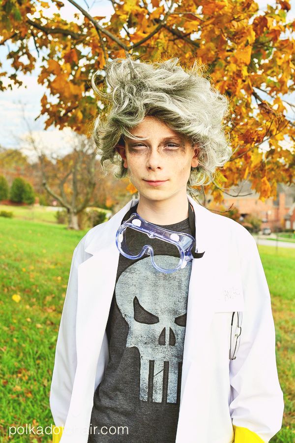 tween boy, about 12 years old, wearing diy mad scientist halloween costume with disheveled gray wig, goggles, skull t shirt