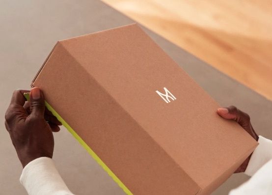 hands holding a madefor box
