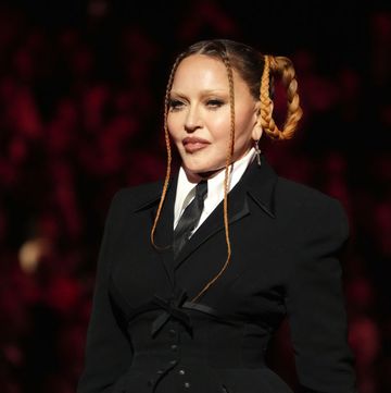 madonna at the grammy awards in 2023, in a black suit with her hair in raised pigtails