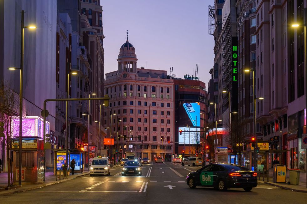 madrid, spain, cars driving in gran via avenue in the downtown district at dusk