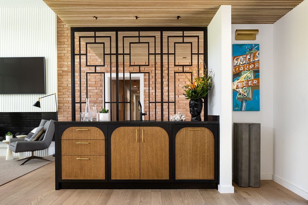 a room with a large wood cabinet and a couch