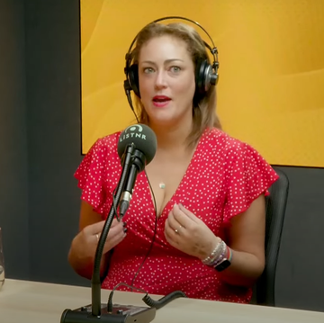 married at first sight australia's clare verrall, sitting at a desk with headphones and a podcast microphone