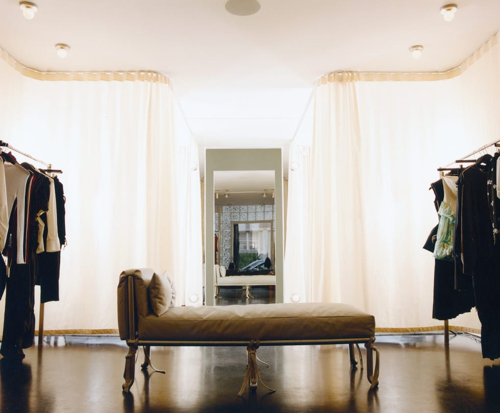 a daybed near the dressing rooms, which have sweeping white curtains, in the williamsburg boutique maimoun