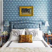 blue bedroom with tiger print pillow