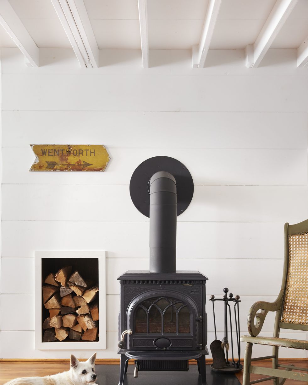 white shiplap room with cast iron stove