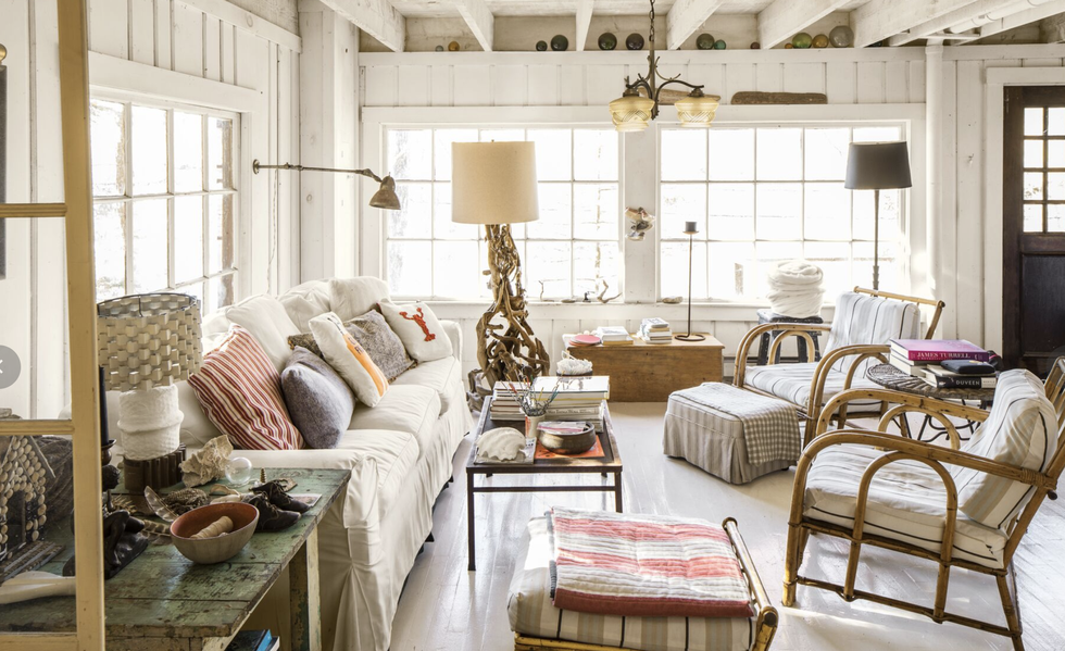 a maine living room with white paneled walls and a slipcovered sofa
