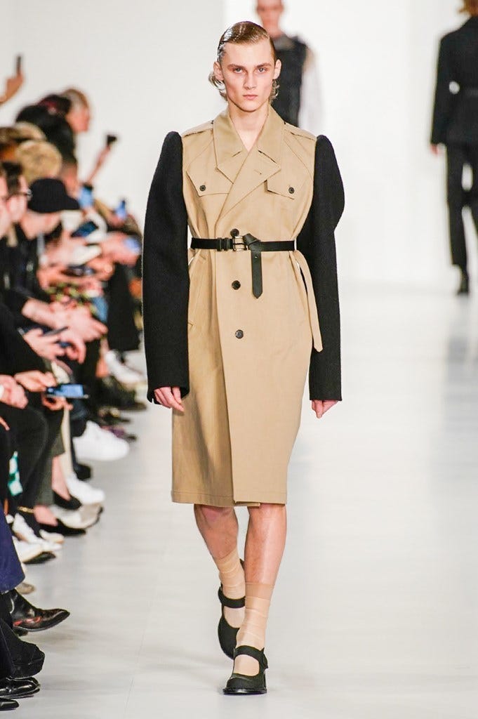 Fashion model, Fashion show, Fashion, Runway, Clothing, Coat, Shoulder, Overcoat, Trench coat, Outerwear, 