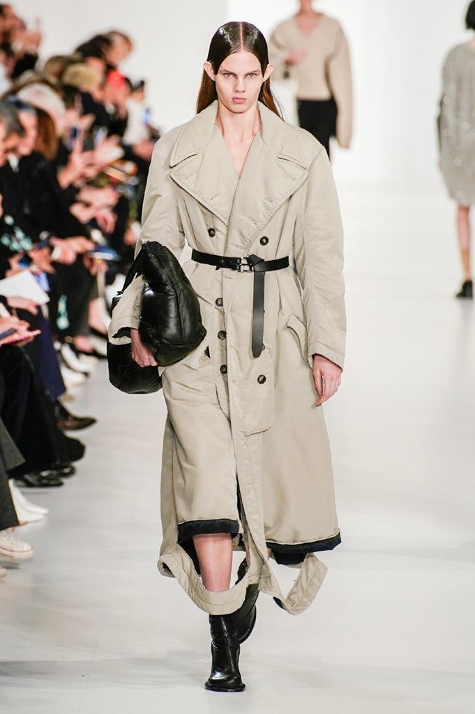 Fashion show, Fashion, Fashion model, Runway, Clothing, Shoulder, Coat, Outerwear, Joint, Trench coat, 