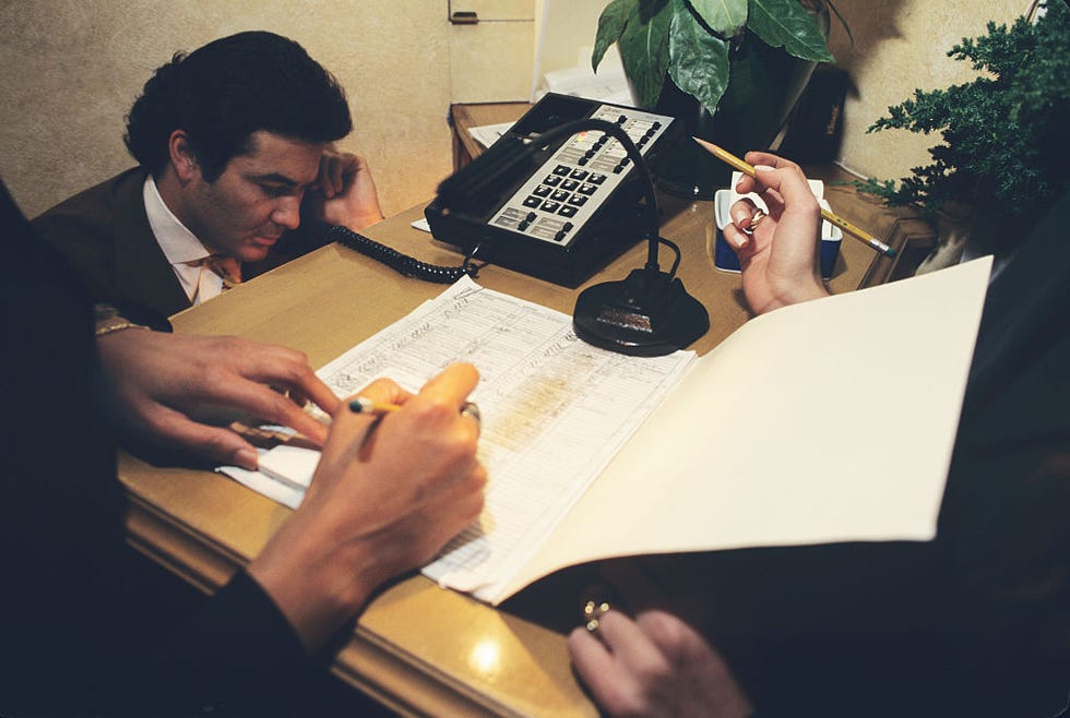 Hostess Checks Reservations at Restaurant