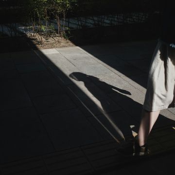 a person's shadow on a sidewalk