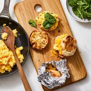 egg and cheese sandwich with spinach on a wooden platter