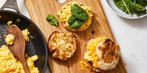egg and cheese sandwich with spinach on a wooden platter