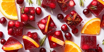 red frozen ice cubes with orange slices and spices