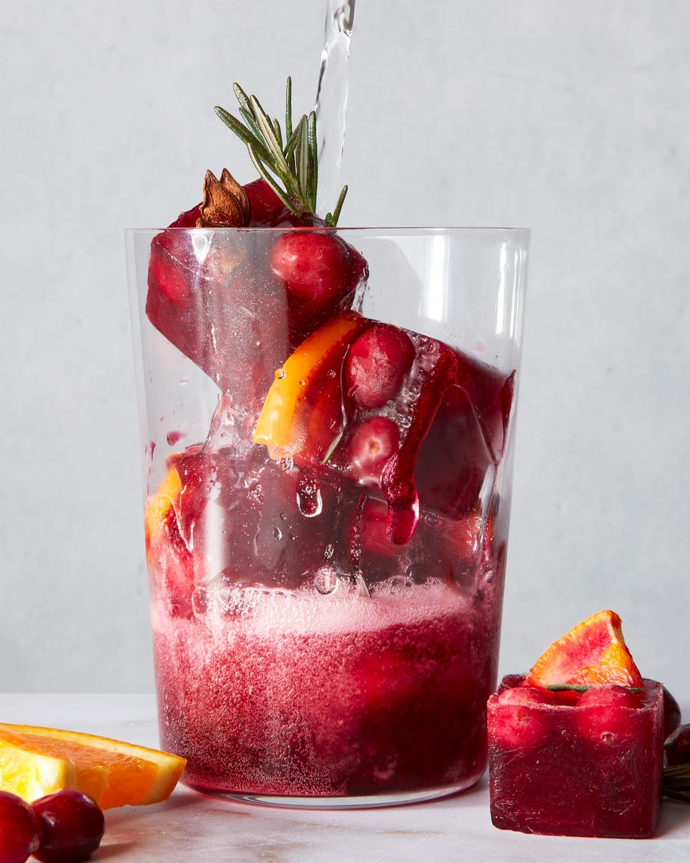 red frozen ice cubes with orange slices and spices