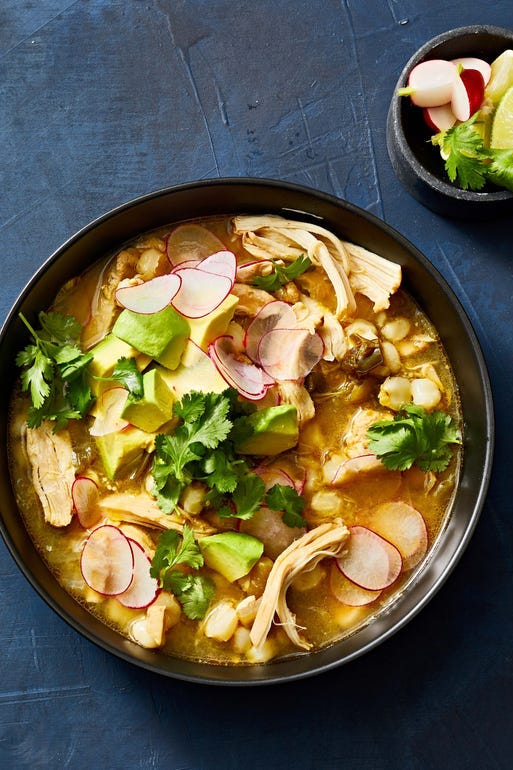 slow cooker chicken pozole verde with sliced radishes in a bowl