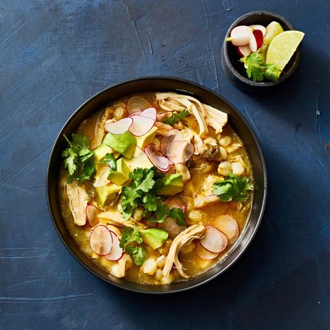 slow cooker chicken pozole verde with sliced radishes in a bowl