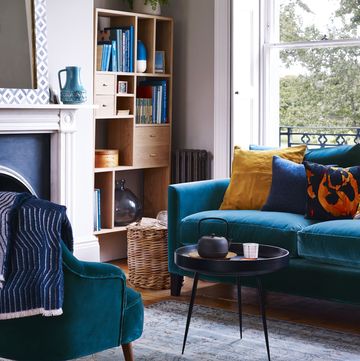 a living room with a blue couch and a coffee table