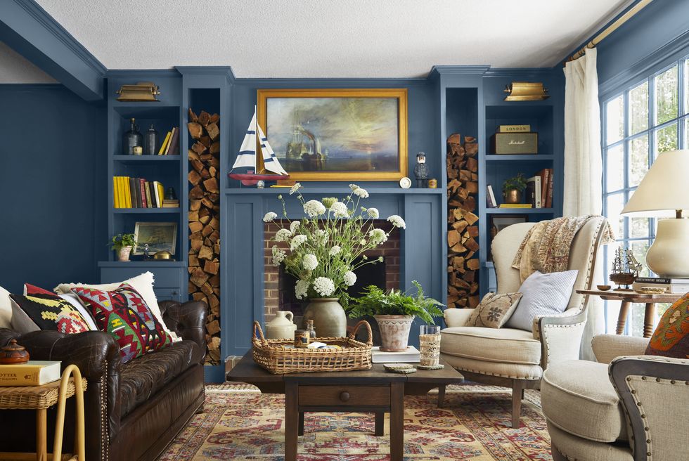 deep blue living room with fireplace and builtin bookcases