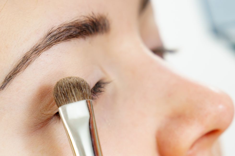 makeup artist applying eye make up