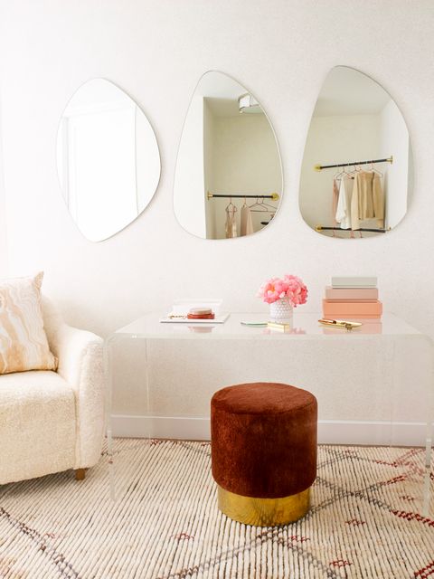 makeup vanity in pink closet with velvet stool