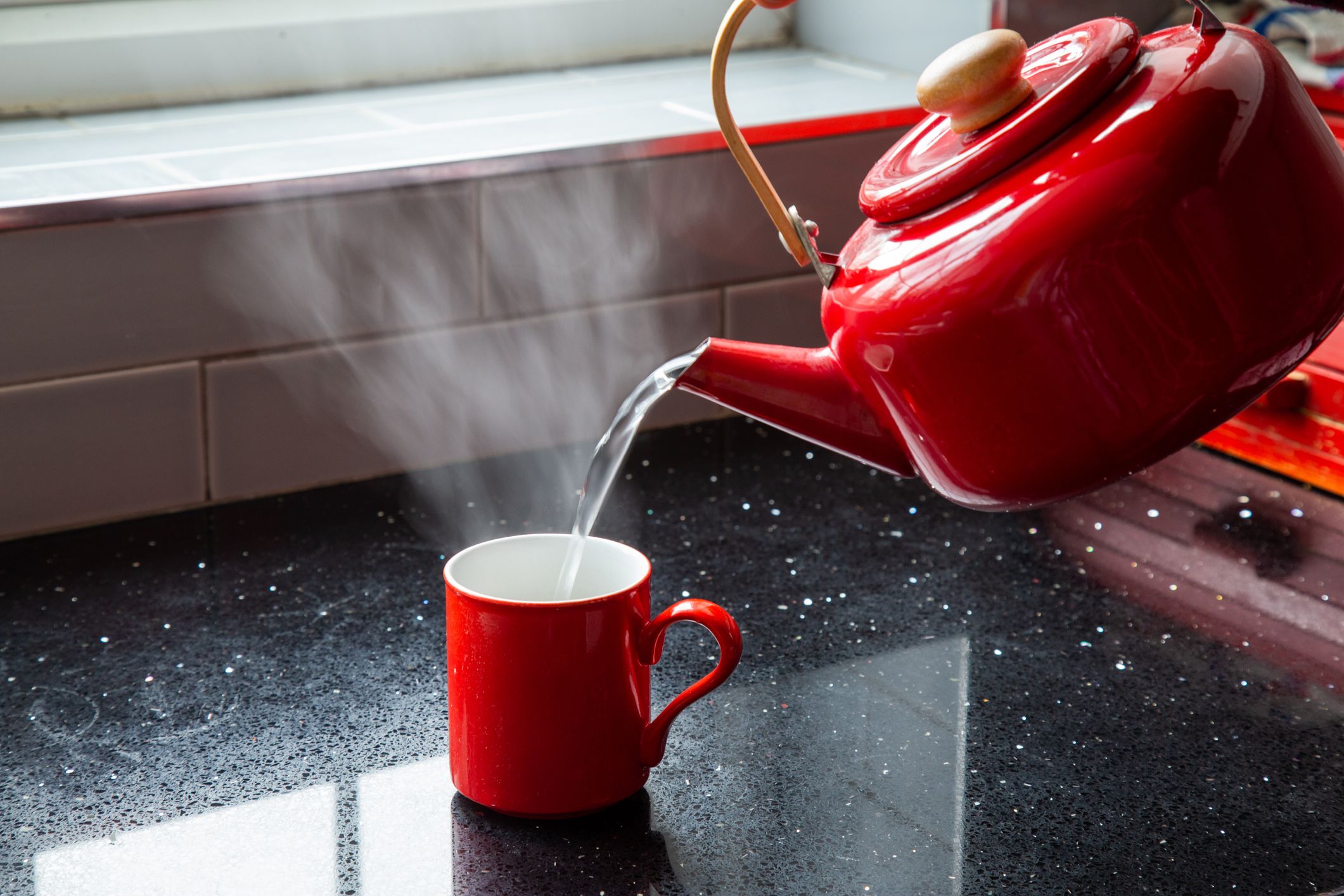 https://hips.hearstapps.com/hmg-prod/images/making-tea-pouring-boiling-water-into-a-mug-royalty-free-image-1669993390.jpg