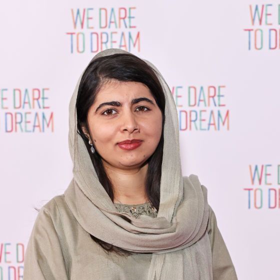 malala yousafzai posing for a photo at a film screening red carpet