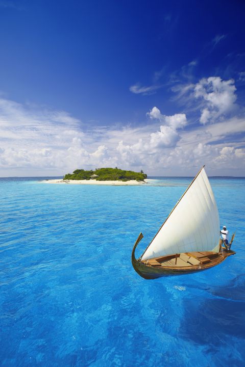 Maldives, sailing boat and tropical island