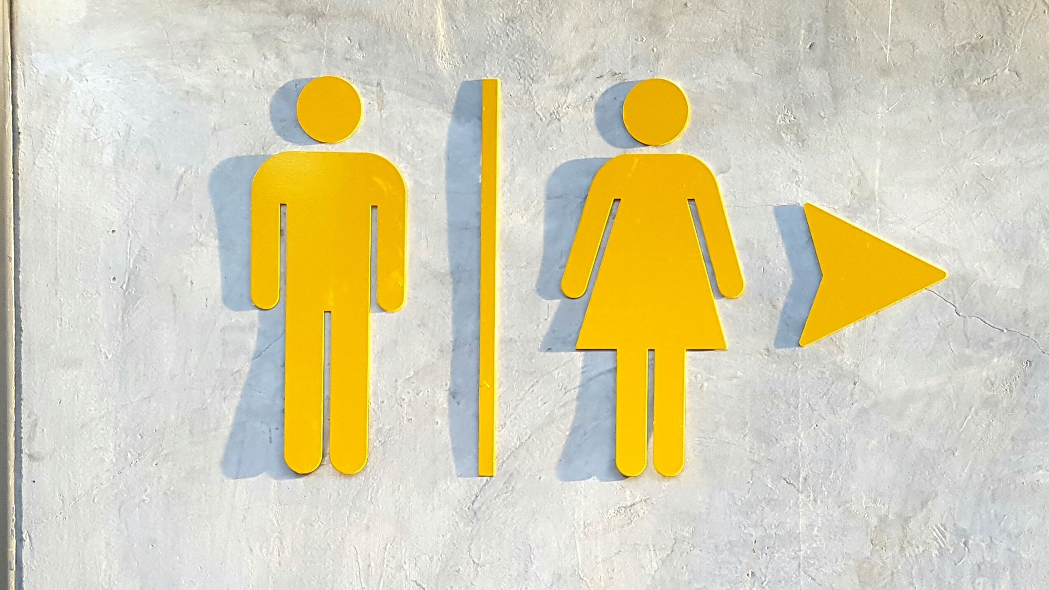 Male And Female Symbol On Wall Of Restroom