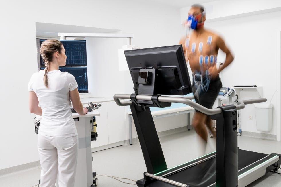 male athlete running on a treadmill and taking a cardio stress test